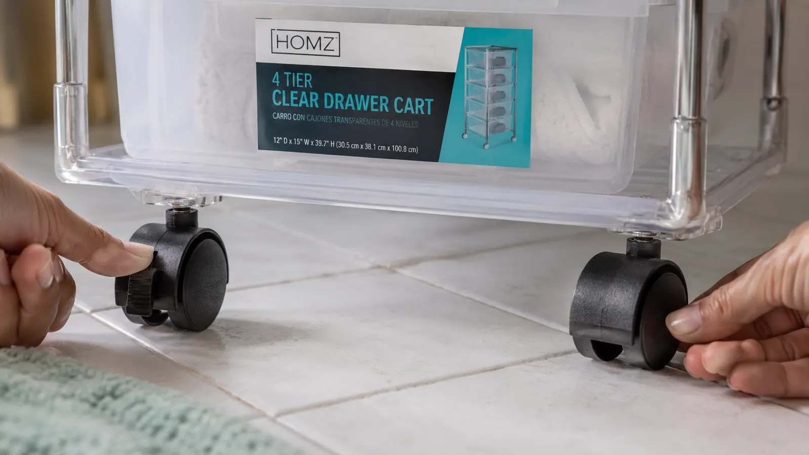 Close-up of the HOMZ drawer cart wheels on a tile floor showing a locked caster next to an unlocked one, with faint tile grout lines visible beneath
