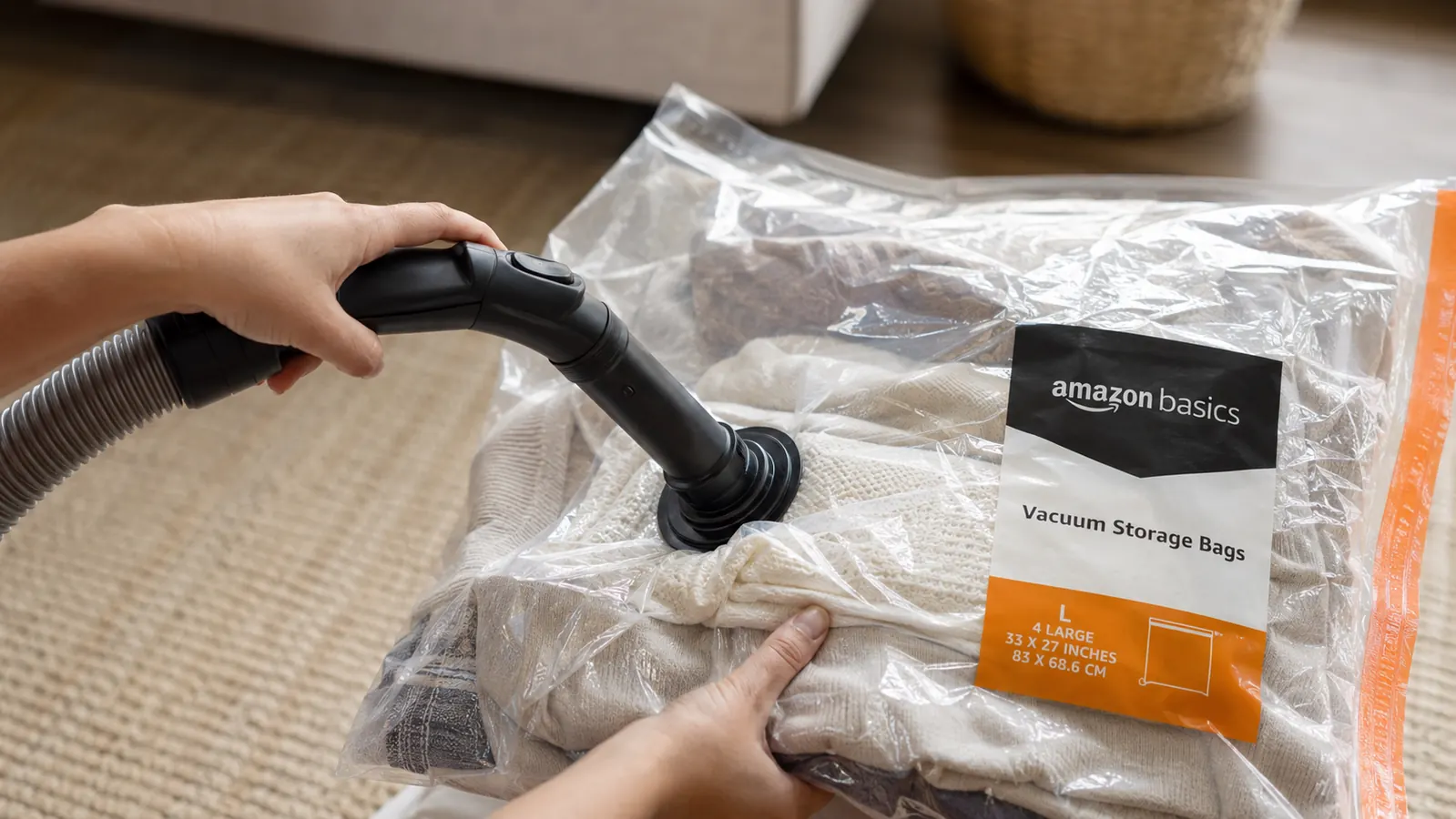 Vacuum hose attached to the valve of a storage bag showing compression in progress