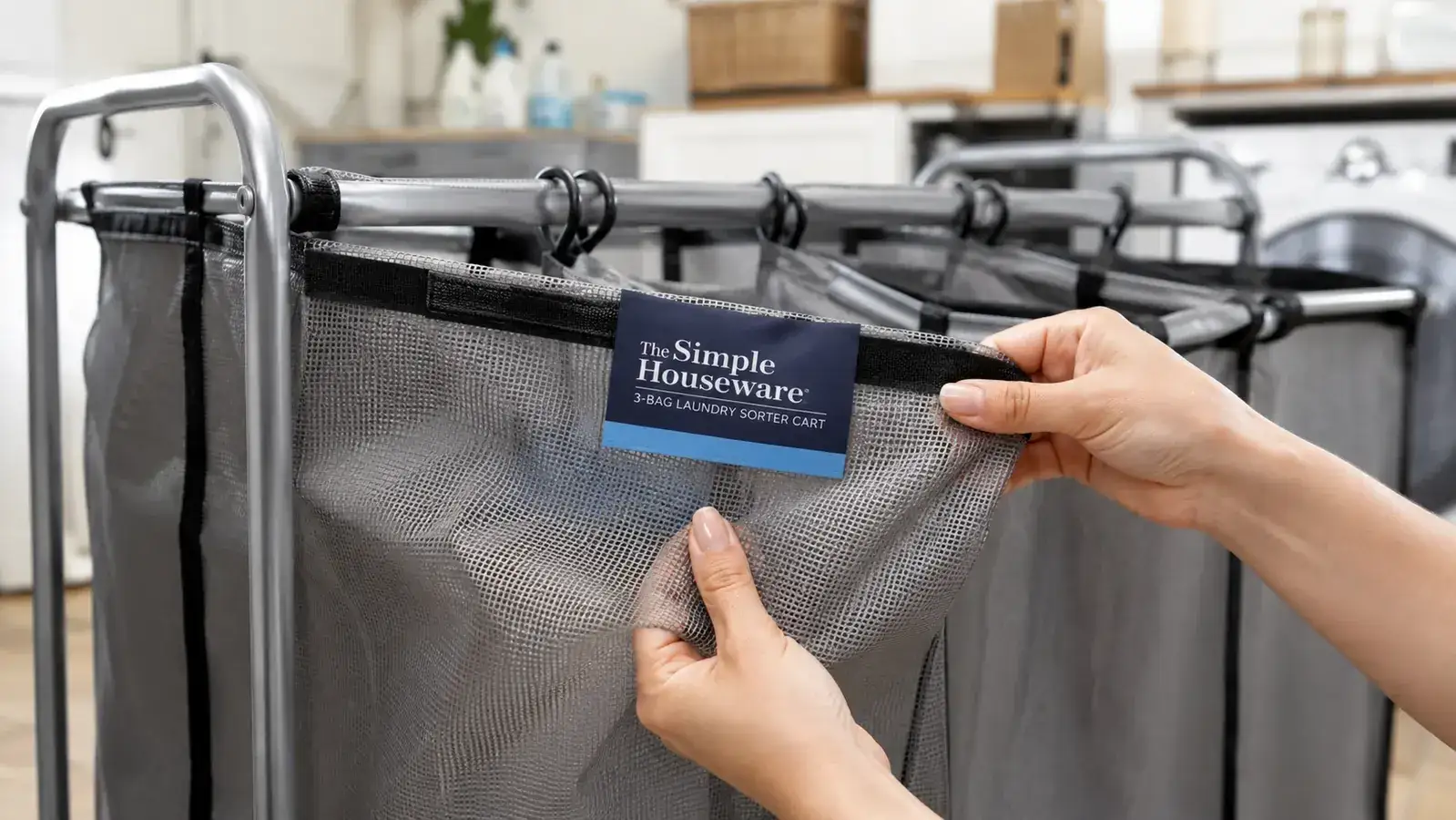 Close-up of the Simple Houseware laundry sorter mesh bag fabric being stretched by a hand to show texture and weave density